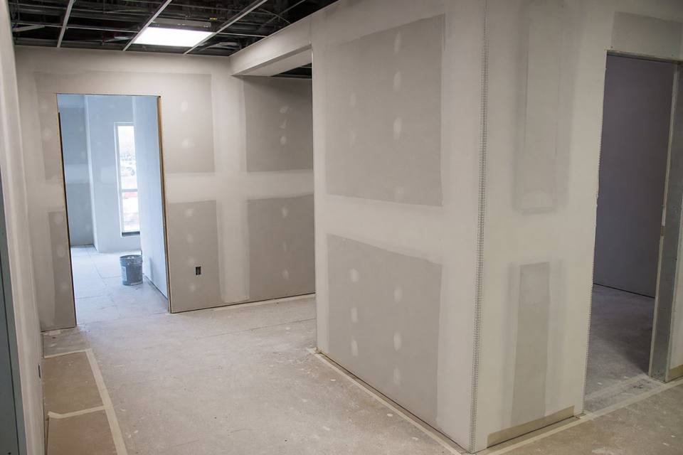 Commercial drywall finishing with corner bead and floor protection for Vero Beach drywall projects