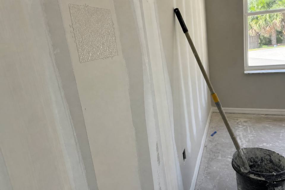 Taped seams and joint compound during drywall finishing for Vero Beach drywall projects